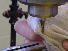 Use a rag to remove cutters from the chuck.